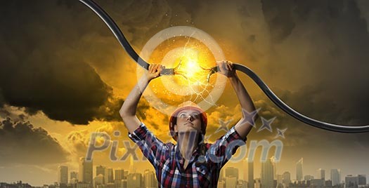 Image of woman holding electricity cable above head Image of woman holding electricity cable above head