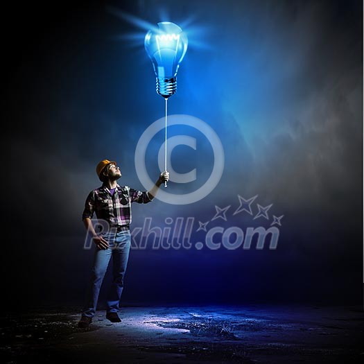 Image of man builder holding electrical bulb Image of man builder holding electrical bulb