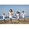 group of happy child on beach who have fun and play games