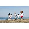 group of happy child on beach who have fun and play games