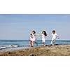 group of happy child on beach who have fun and play games