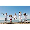 group of happy child on beach who have fun and play games