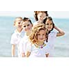 group of happy child on beach who have fun and play games