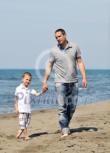 happy young  father and son have fun and enjoy time on beach at sunset and representing healthy family and support concept