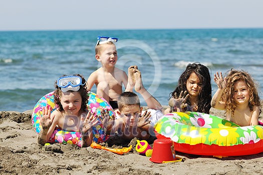 happy child group have fun on beach while playing with toys  running jumping