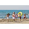 happy child group have fun on beach while playing with toys  running jumping