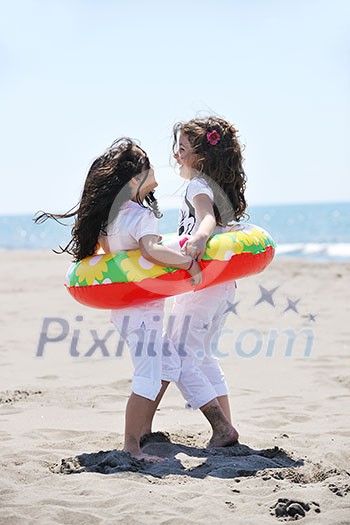 group of happy child on beach who have fun and play games