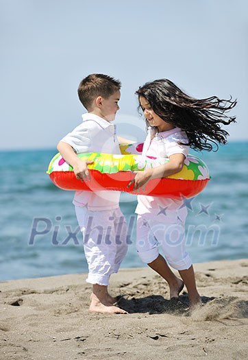 group of happy child on beach who have fun and play games