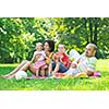 happy young couple with their children have fun at beautiful park outdoor in nature