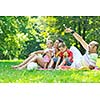 happy young couple with their children have fun at beautiful park outdoor in nature