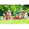 happy young couple with their children have fun at beautiful park outdoor in nature