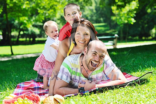 happy young couple with their children have fun at beautiful park outdoor in nature happy young couple with their children have fun at beautiful park outdoor in nature