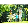 happy young couple with their children have fun at beautiful park outdoor in nature