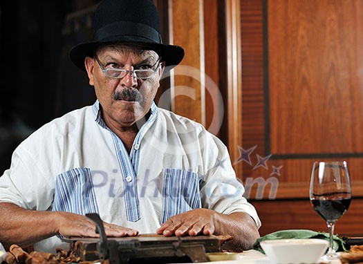 older senior man making luxury handmade cuban cigare older senior man making luxury handmade cuban cigare