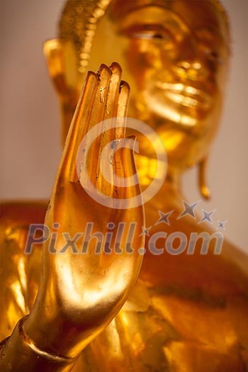 Buddha golden statue blessing hand, Wat Pho, Bangkok,  Thailand. Low point of view