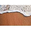 Wave surging on sand on beach