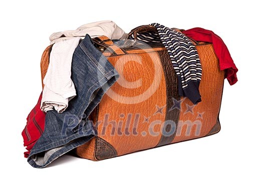 Overstuffed baggage in old suitcase isolated on white background