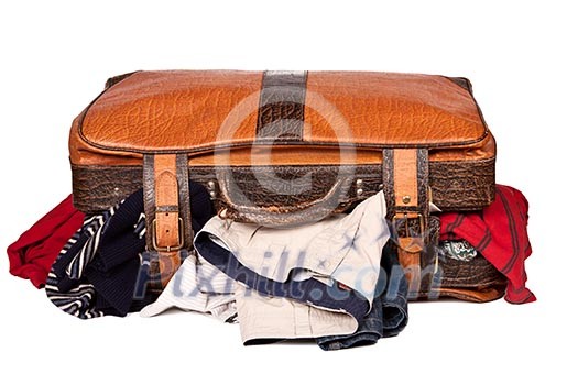 Overstuffed baggage in old suitcase isolated on white background