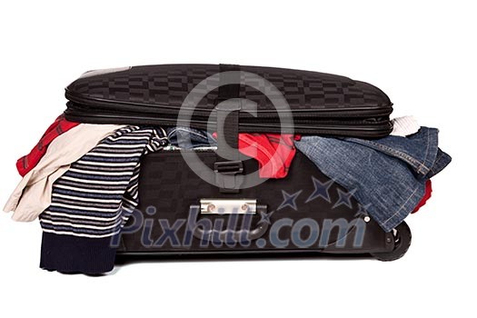 Overstuffed baggage in old suitcase isolated on white background