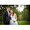 Just married, young wedding couple in a park, walking, savoring the moment on her big day (shallow DOF)