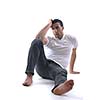 portrait of relaxed young man dressed in white shirt and jeans isolated over white background in studio