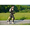 Young couple jogging in park at morning. Health and fitness.