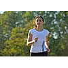 Young beautiful  woman jogging on morning at  park. Woman in sport outdoors health concept