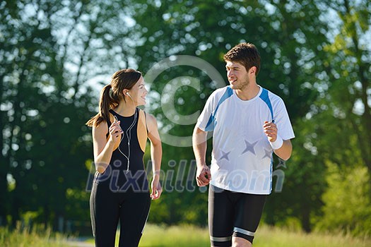Young couple jogging in park at morning. Health and fitness concept Young couple jogging in park at morning. Health and fitness concept