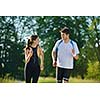 Young couple jogging in park at morning. Health and fitness concept