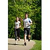 Young couple jogging in park at morning. Health and fitness concept