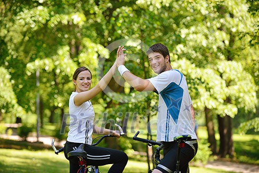 Happy couple ride bicycle outdoors, health lifestyle fun love romance concept