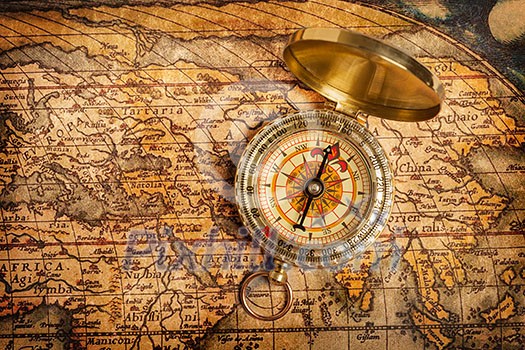 Old vintage retro golden compass on ancient map Old vintage retro golden compass on ancient map