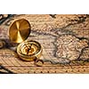 Old vintage retro golden compass on ancient map