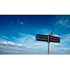 Blank signpost in sky with clouds