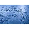 Water droplets on metal background macro blue tinted