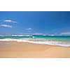 Peaceful beach scene with ocean and blue sky