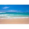 Peaceful beach scene with ocean and blue sky