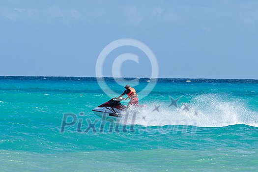 Man riding jet ski in Caribbean sea Man riding jet ski in Caribbean sea