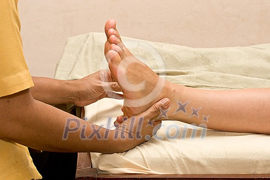 Foot massage in spa close up