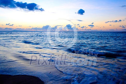 Calm peaceful ocean and beach on tropical sunrise Calm peaceful ocean and beach on tropical sunrise