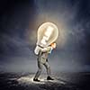 Image of businessman carrying bulb on back. New idea