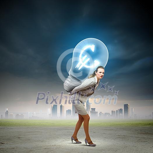 Image of businesswoman holding bulb on back Image of businesswoman holding bulb on back