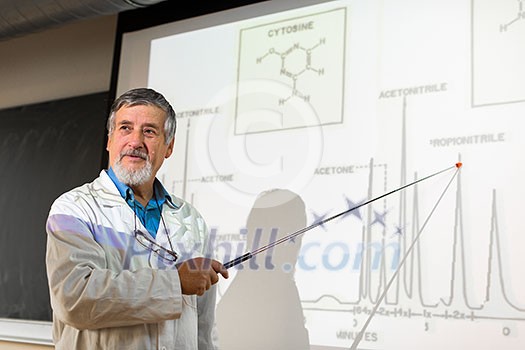 Senior chemistry professor giving a lecture in front of classroom full of students (shallow DOF; color toned image) Senior chemistry professor giving a lecture in front of classroom full of students (shallow DOF; color toned image)