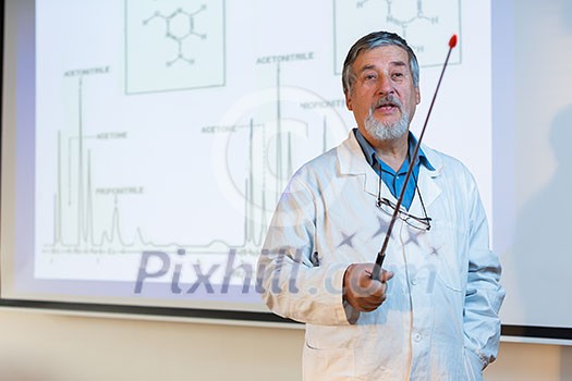 Senior chemistry professor giving a lecture in front of classroom full of students (shallow DOF; color toned image) Senior chemistry professor giving a lecture in front of classroom full of students (shallow DOF; color toned image)