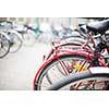Bike rental service - Many bikes standing in bike stands, available for rent as a great mean of transport in the city