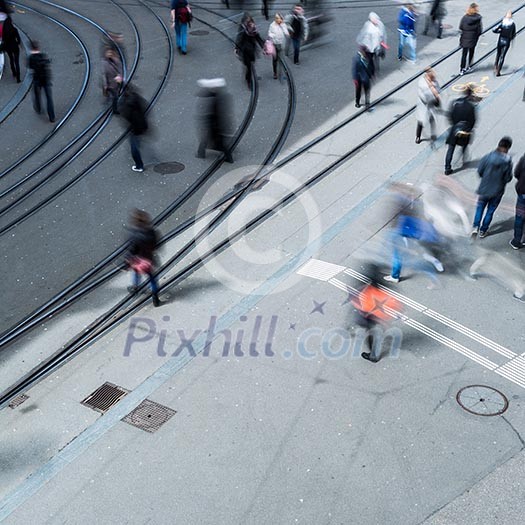 urban traffic concept - city street with a motion blurred crowd crossing a road