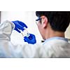 Male researcher carrying out research in a chemistry lab (color toned image; shallow DOF)