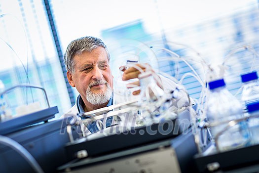 Senior male researcher carrying out scientific research in a lab (shallow DOF; color toned image) Senior male researcher carrying out scientific research in a lab (shallow DOF; color toned image)