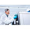 Senior male researcher carrying out scientific research in a lab (shallow DOF; color toned image)