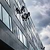Climbers washing windows of a modern high-rise building